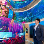 An attendee admires a 360-degree digital screen installation at LEAP, the world’s most attended technology event.